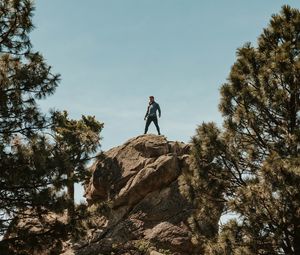 Preview wallpaper man, rock, trees, stones, height