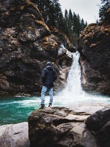 Preview wallpaper man, rock, waterfall, river, nature