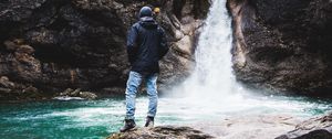 Preview wallpaper man, rock, waterfall, river, nature