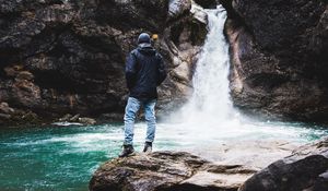 Preview wallpaper man, rock, waterfall, river, nature