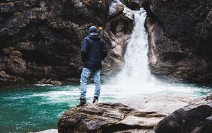 Preview wallpaper man, rock, waterfall, river, nature