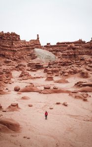 Preview wallpaper man, rocks, desert, alone, aerial view