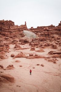 Preview wallpaper man, rocks, desert, alone, aerial view