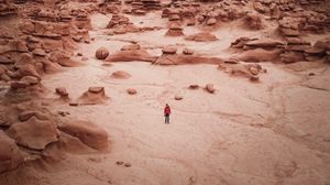Preview wallpaper man, rocks, desert, alone, aerial view