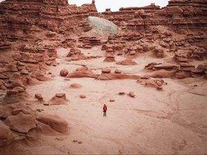 Preview wallpaper man, rocks, desert, alone, aerial view