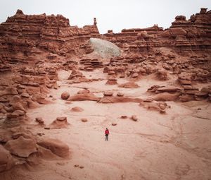 Preview wallpaper man, rocks, desert, alone, aerial view