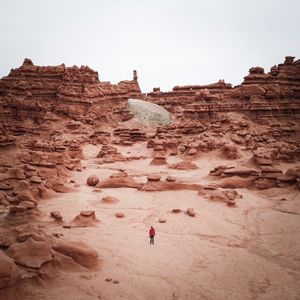Preview wallpaper man, rocks, desert, alone, aerial view