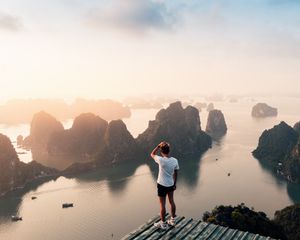 Preview wallpaper man, rocks, water, height, view, overview
