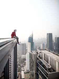 Preview wallpaper man, roof, city, buildings, height, overview