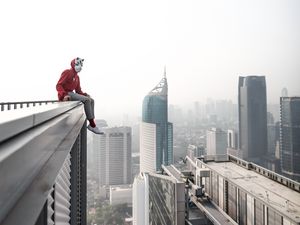 Preview wallpaper man, roof, city, buildings, height, overview