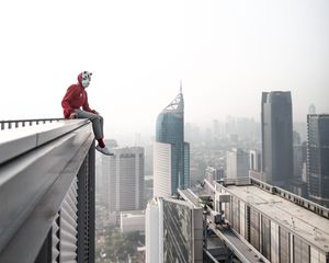 Preview wallpaper man, roof, city, buildings, height, overview