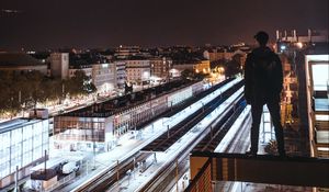 Preview wallpaper man, roof, dark, night city, overview