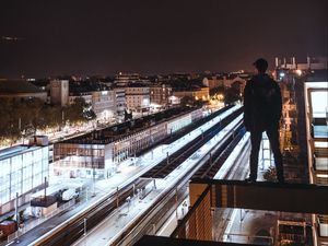 Preview wallpaper man, roof, dark, night city, overview