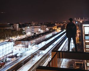 Preview wallpaper man, roof, dark, night city, overview