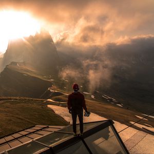 Preview wallpaper man, roof, mountains, height, clouds, fog, sunlight