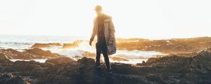 Preview wallpaper man, sea, coast, sunlight, waves