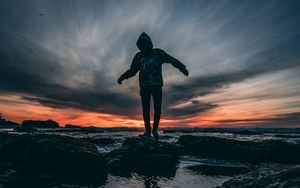 Preview wallpaper man, sea, sunset, stones, loneliness