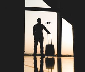 Preview wallpaper man, silhouette, airport, travel, suitcase