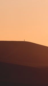 Preview wallpaper man, silhouette, alone, desert, sand, hills, brown