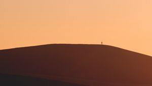 Preview wallpaper man, silhouette, alone, desert, sand, hills, brown