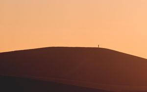 Preview wallpaper man, silhouette, alone, desert, sand, hills, brown