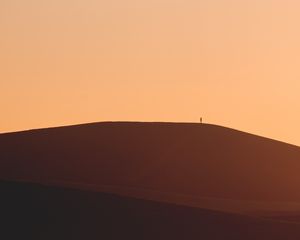 Preview wallpaper man, silhouette, alone, desert, sand, hills, brown