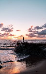 Preview wallpaper man, silhouette, alone, rock, sea, sunset