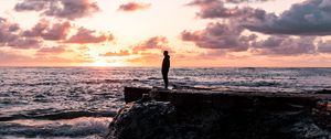 Preview wallpaper man, silhouette, alone, rock, sea, sunset