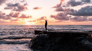 Preview wallpaper man, silhouette, alone, rock, sea, sunset