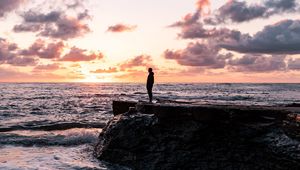 Preview wallpaper man, silhouette, alone, rock, sea, sunset
