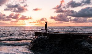 Preview wallpaper man, silhouette, alone, rock, sea, sunset