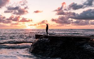 Preview wallpaper man, silhouette, alone, rock, sea, sunset