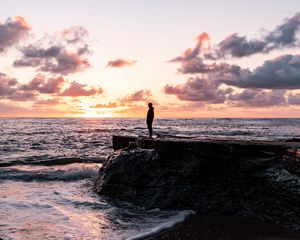 Preview wallpaper man, silhouette, alone, rock, sea, sunset