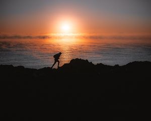 Preview wallpaper man, silhouette, alone, shore, water, sunset, dark