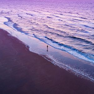 Preview wallpaper man, silhouette, alone, beach, sea, aerial view, purple