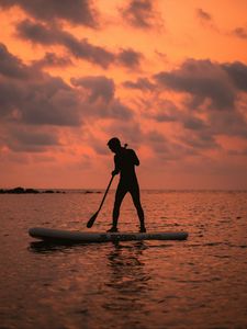 Preview wallpaper man, silhouette, alone, boat, water, sunset, dark