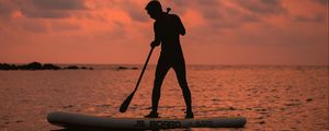 Preview wallpaper man, silhouette, alone, boat, water, sunset, dark