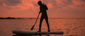 Preview wallpaper man, silhouette, alone, boat, water, sunset, dark