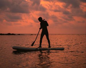 Preview wallpaper man, silhouette, alone, boat, water, sunset, dark