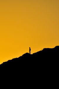 Preview wallpaper man, silhouette, alone, slope, dark, yellow