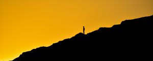 Preview wallpaper man, silhouette, alone, slope, dark, yellow