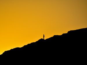 Preview wallpaper man, silhouette, alone, slope, dark, yellow