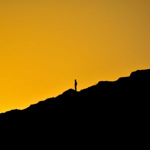 Preview wallpaper man, silhouette, alone, slope, dark, yellow