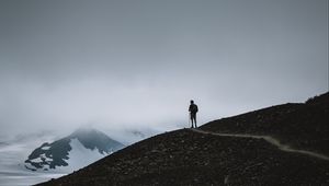 Preview wallpaper man, silhouette, alone, mountains, dusk, nature