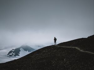 Preview wallpaper man, silhouette, alone, mountains, dusk, nature