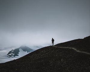 Preview wallpaper man, silhouette, alone, mountains, dusk, nature