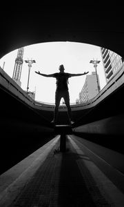 Preview wallpaper man, silhouette, bw, freedom, light, architecture