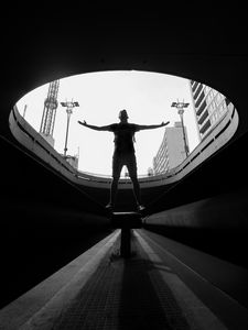 Preview wallpaper man, silhouette, bw, freedom, light, architecture