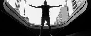 Preview wallpaper man, silhouette, bw, freedom, light, architecture