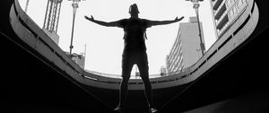 Preview wallpaper man, silhouette, bw, freedom, light, architecture